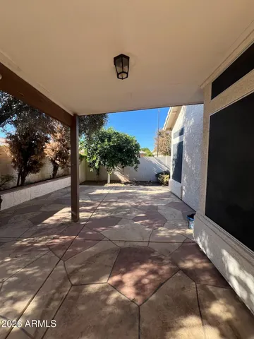 a backyard of a house with a table and chairs