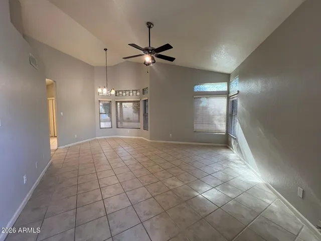 a view of an empty room and a ceiling fan