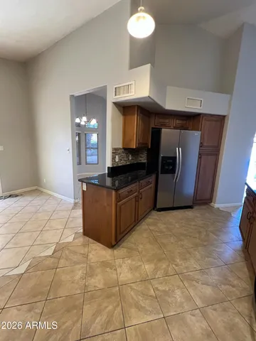 a kitchen with granite countertop a stove a sink and a microwave