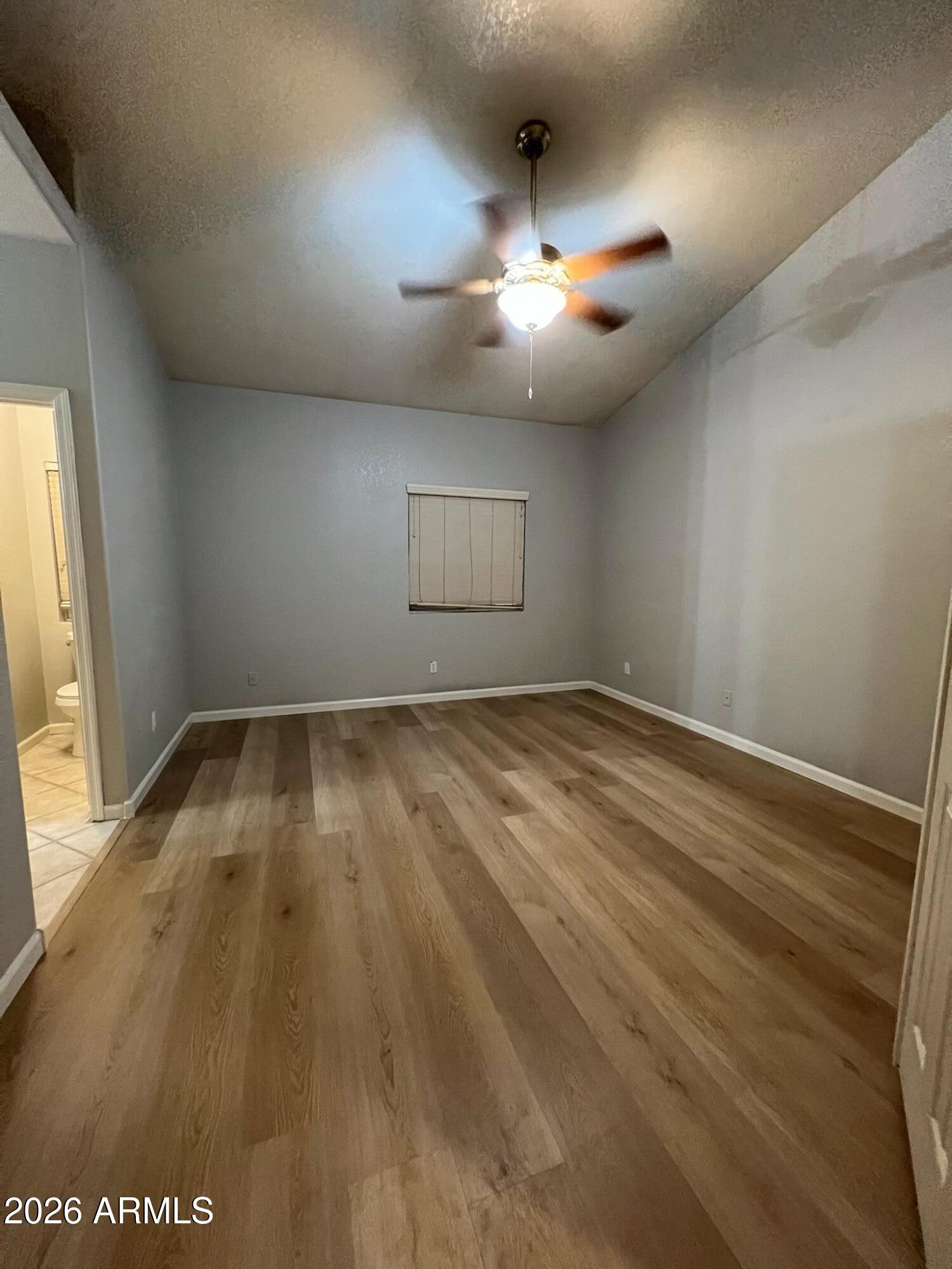 261 West Verano Place Gilbert, AZ 85233 - Photo 9 of 17 an empty room with a window and ceiling fan