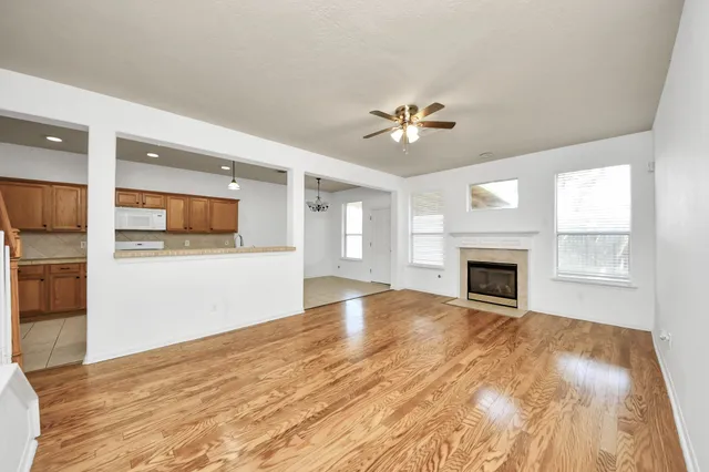 a large kitchen with a large counter top a sink and stainless steel appliances