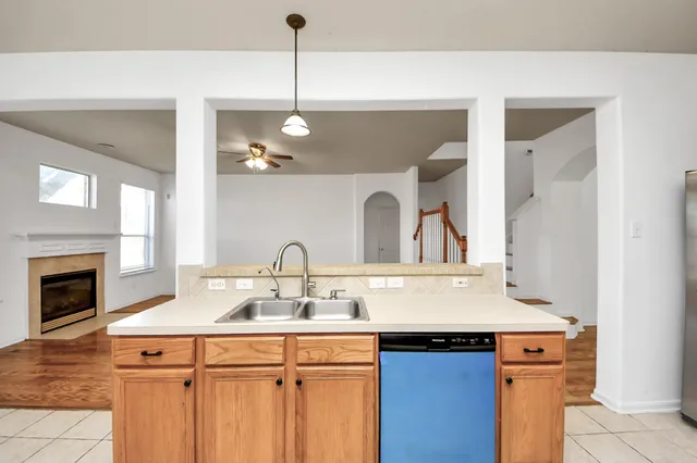 an empty room with a window and a ceiling fan
