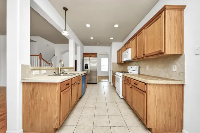a bathroom with a tub sink and mirror