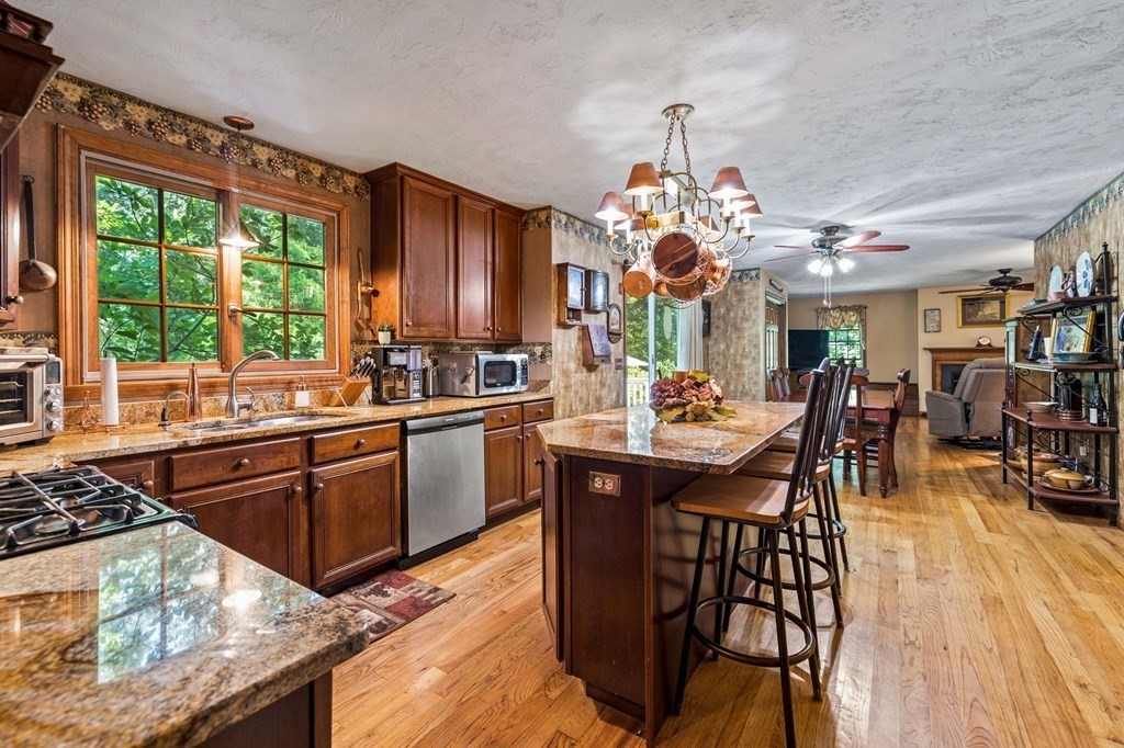 28 Crowell Road Bourne, MA 02562 - Photo 17 of 42 a kitchen with a table chairs stove and cabinets