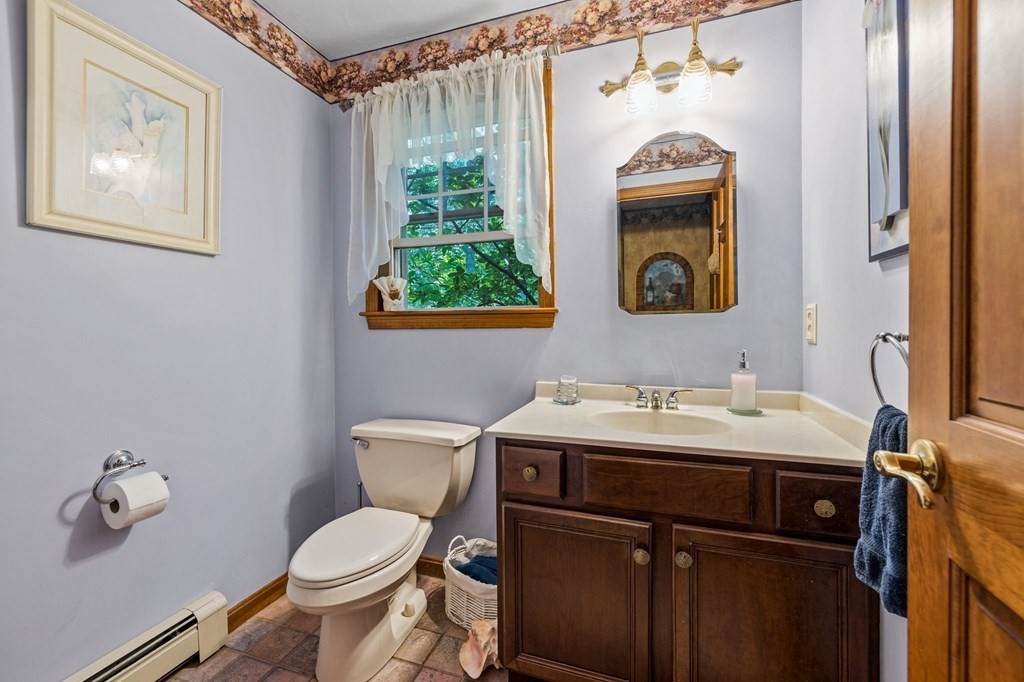 28 Crowell Road Bourne, MA 02562 - Photo 23 of 42 a bathroom with a toilet sink and mirror