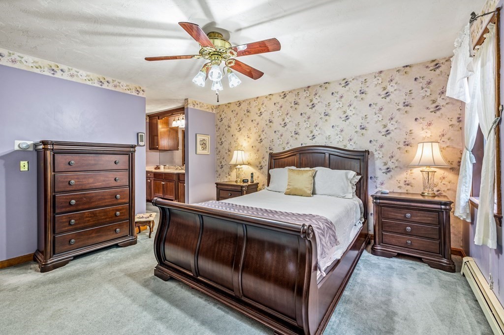 28 Crowell Road Bourne, MA 02562 - Photo 24 of 42 a bedroom with a bed and a chandelier