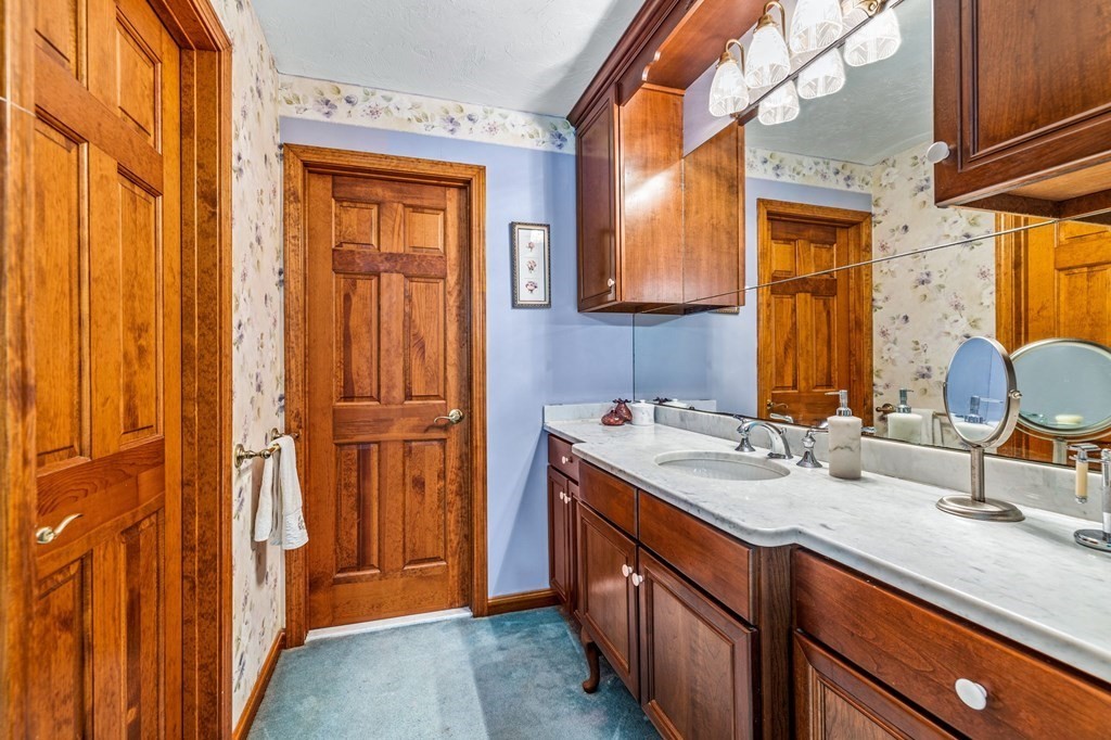 28 Crowell Road Bourne, MA 02562 - Photo 27 of 42 a bathroom with a sink a vanity and a mirror