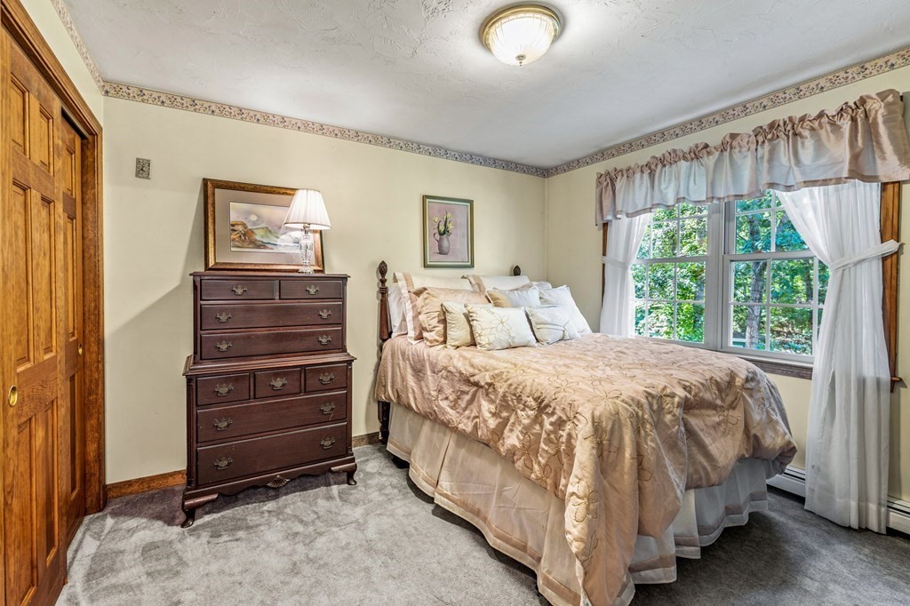 28 Crowell Road Bourne, MA 02562 - Photo 29 of 42 a large bed sitting in a bedroom next to a window
