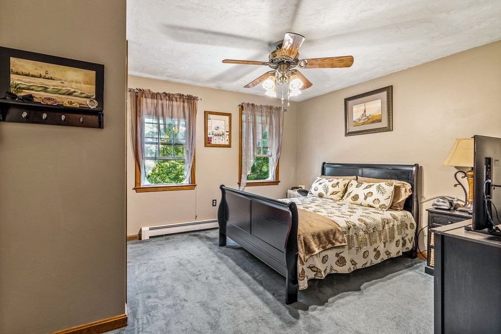 28 Crowell Road Bourne, MA 02562 - Photo 30 of 42 a bedroom with a bed and a chandelier