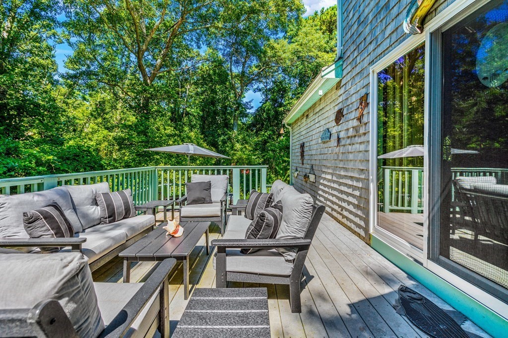 28 Crowell Road Bourne, MA 02562 - Photo 31 of 42 a balcony with wooden floor and outdoor seating