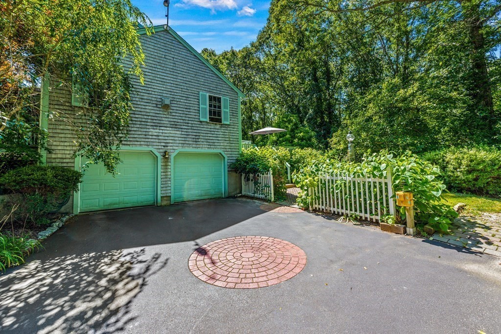 28 Crowell Road Bourne, MA 02562 - Photo 8 of 42 a view of a backyard with a large tree