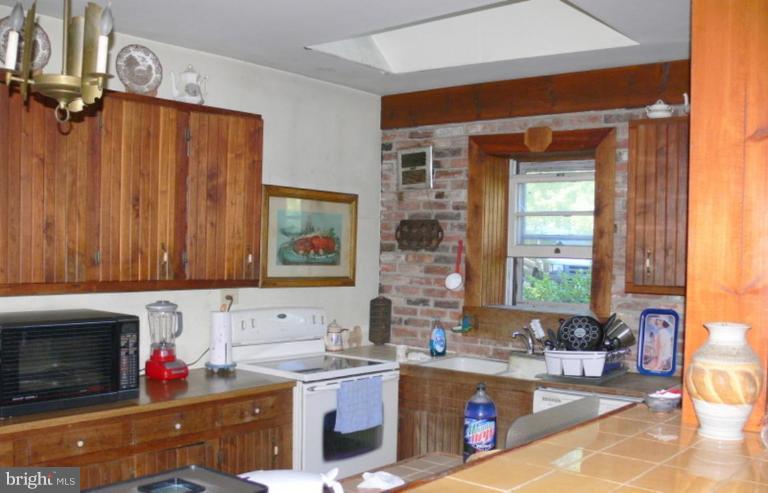 6214 Washington Monument Road Boonsboro, MD 21713 - Photo 5 of 8 a kitchen with a stove a sink and a microwave