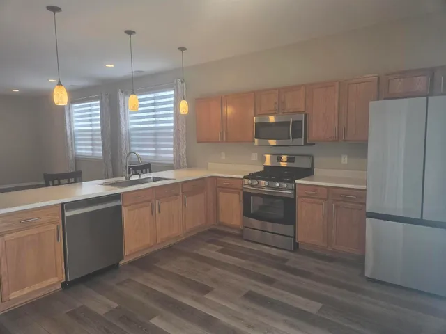 a stove top oven sitting inside of a kitchen