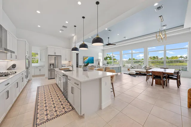 a kitchen with stainless steel appliances a sink a stove a refrigerator cabinets and a counter top space