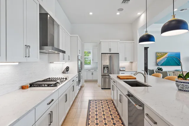 a large kitchen with a table and chairs