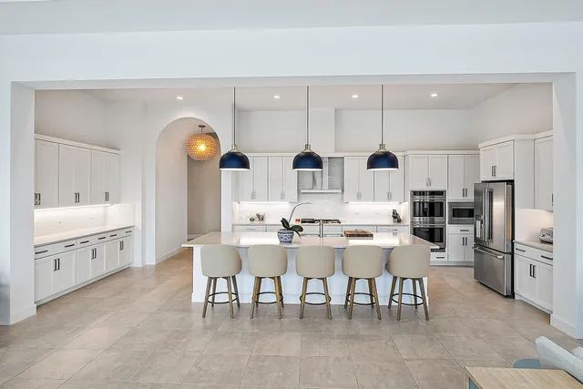 a living room with lots of furniture and kitchen view