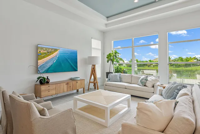 a view of a dining room with furniture and a chandelier