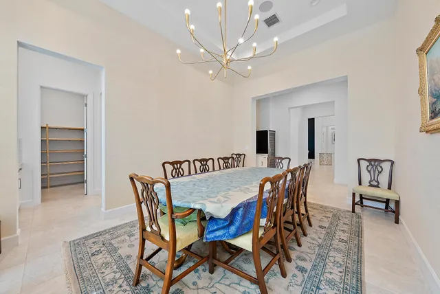 a bedroom with a bed and a large mirror on the dresser
