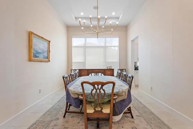 a spacious bedroom with a bed and a chandelier