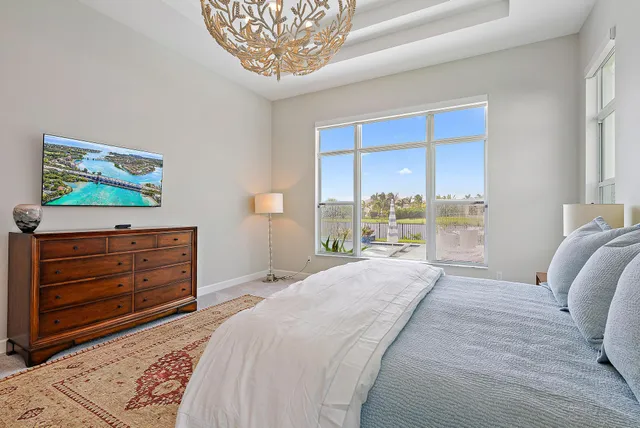 a bathroom with a granite countertop sink a large mirror and a window