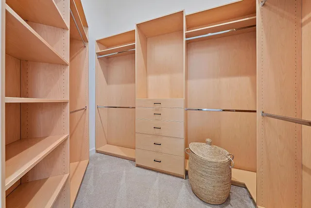 a spacious bathroom with a granite countertop toilet a sink and a mirror
