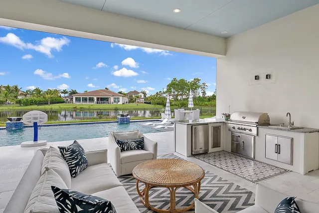 a front view of a house with a yard and potted plants