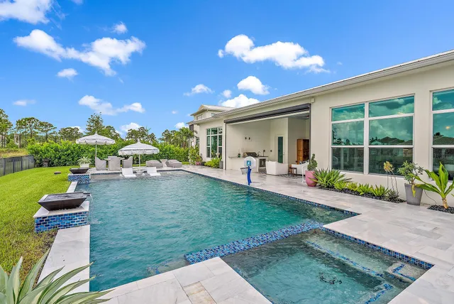 an aerial view of a house with a garden and lake view