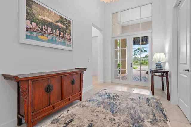 a living room with dining table and a large window