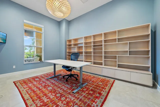 a kitchen with stainless steel appliances a dining table chairs sink and microwave