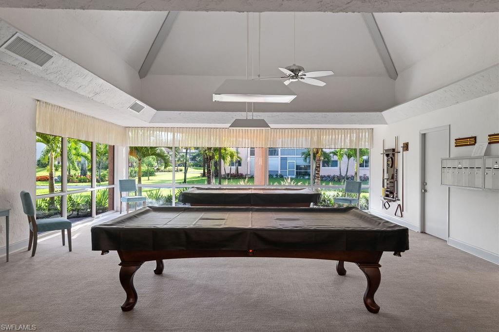 170 Turtle Lake Court, Unit 210 Naples, FL 34105 - Photo 15 of 20 a living room with furniture and a large window