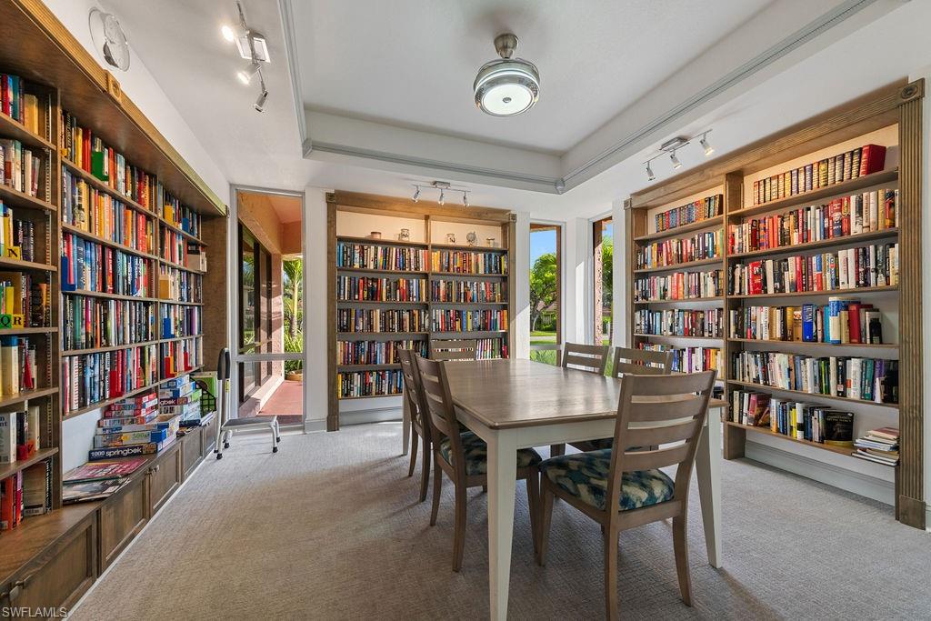 170 Turtle Lake Court, Unit 210 Naples, FL 34105 - Photo 18 of 20 a view of a dining room with furniture and a bookshelf