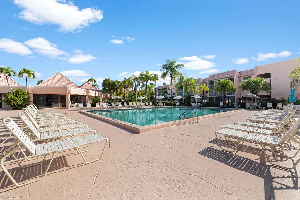 170 Turtle Lake Court, Unit 210 Naples, FL 34105 - Photo 20 of 20 a view of a patio with a table and chairs