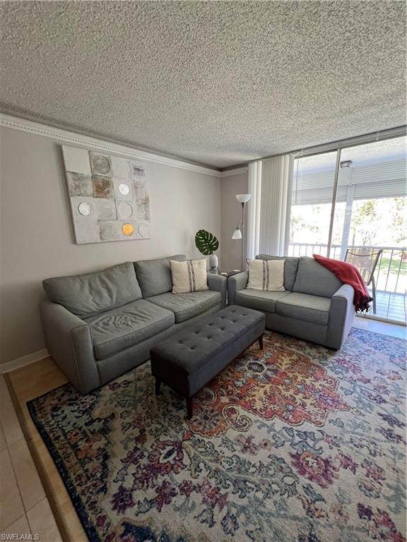 170 Turtle Lake Court, Unit 210 Naples, FL 34105 - Photo 2 of 20 a living room with furniture or couch and a large window