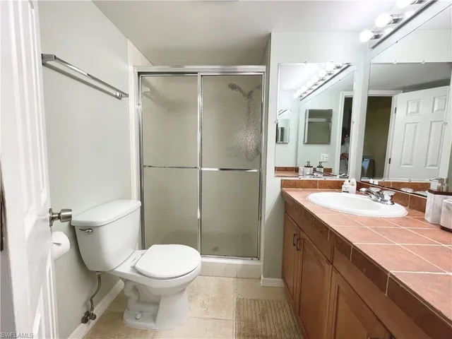 a bathroom with a toilet a sink and shower