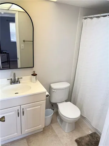 a bathroom with a toilet a sink and a mirror
