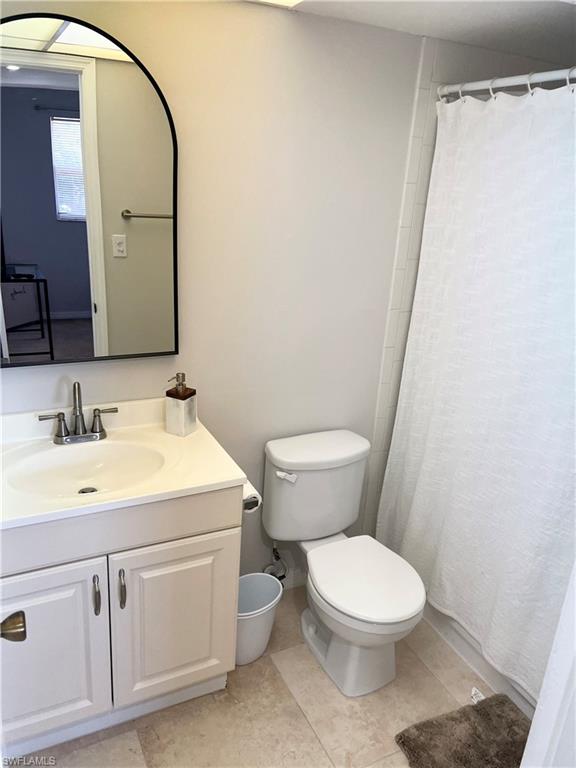 170 Turtle Lake Court, Unit 210 Naples, FL 34105 - Photo 8 of 20 a bathroom with a toilet a sink and a mirror