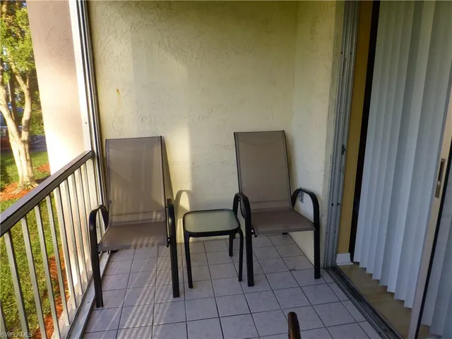 a view of a hallway with chairs and furniture