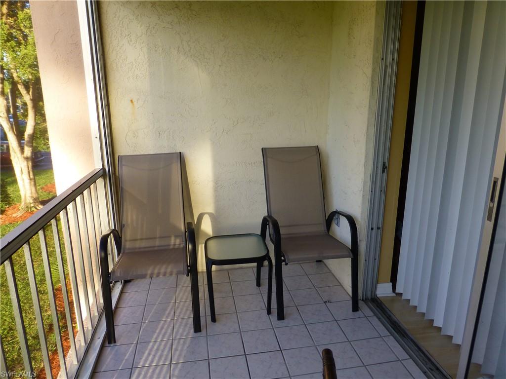 170 Turtle Lake Court, Unit 210 Naples, FL 34105 - Photo 9 of 20 a view of a hallway with chairs and furniture