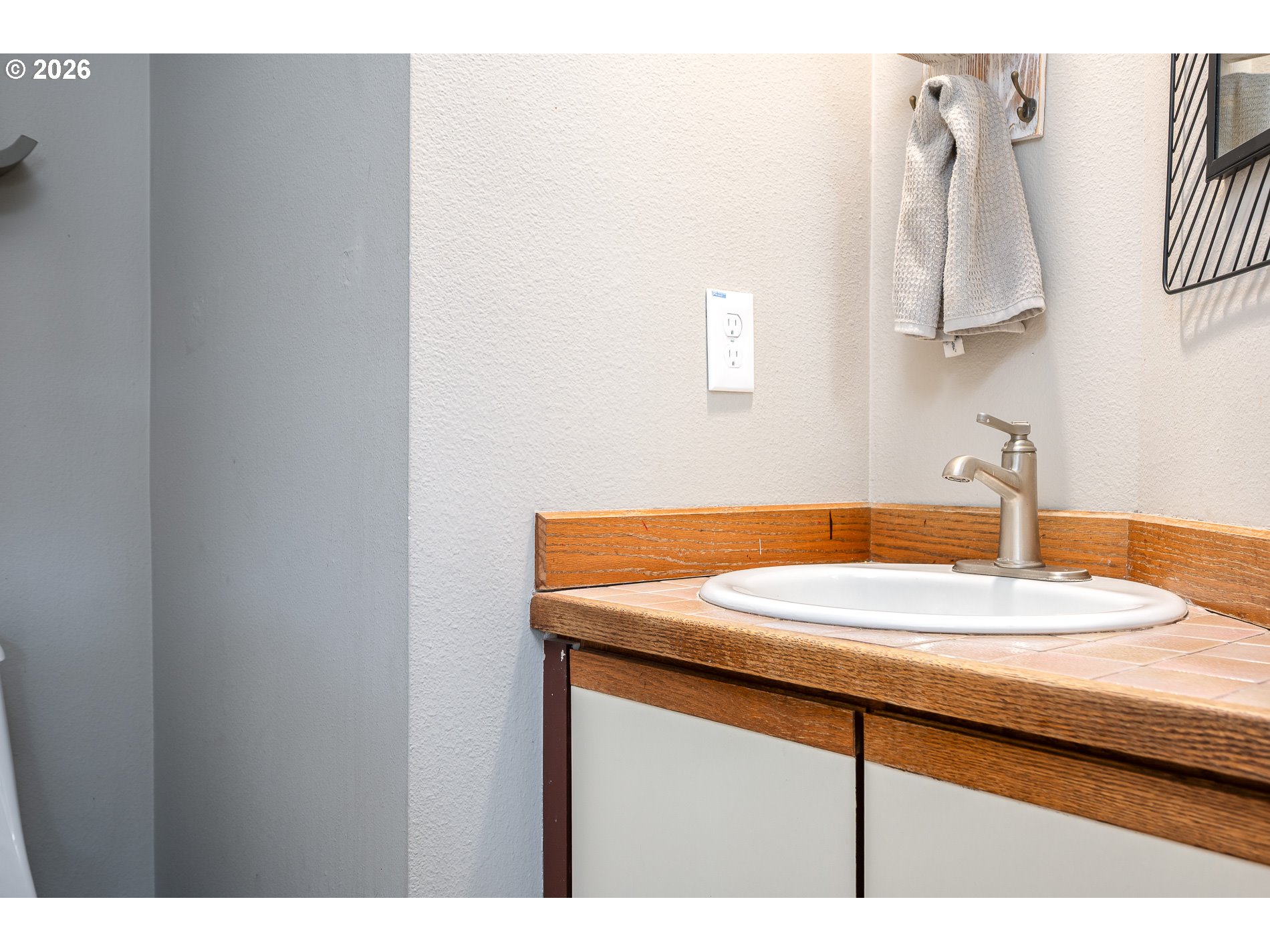 8670 Southwest Stratford Court Tigard, OR 97224 - Photo 15 of 42 a bathroom with a sink and a mirror