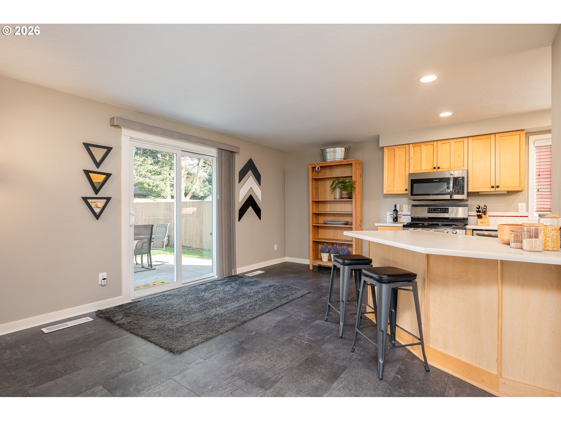 8670 Southwest Stratford Court Tigard, OR 97224 - Photo 16 of 42 a kitchen with stainless steel appliances granite countertop a stove top oven a sink dishwasher and a refrigerator with wooden floor