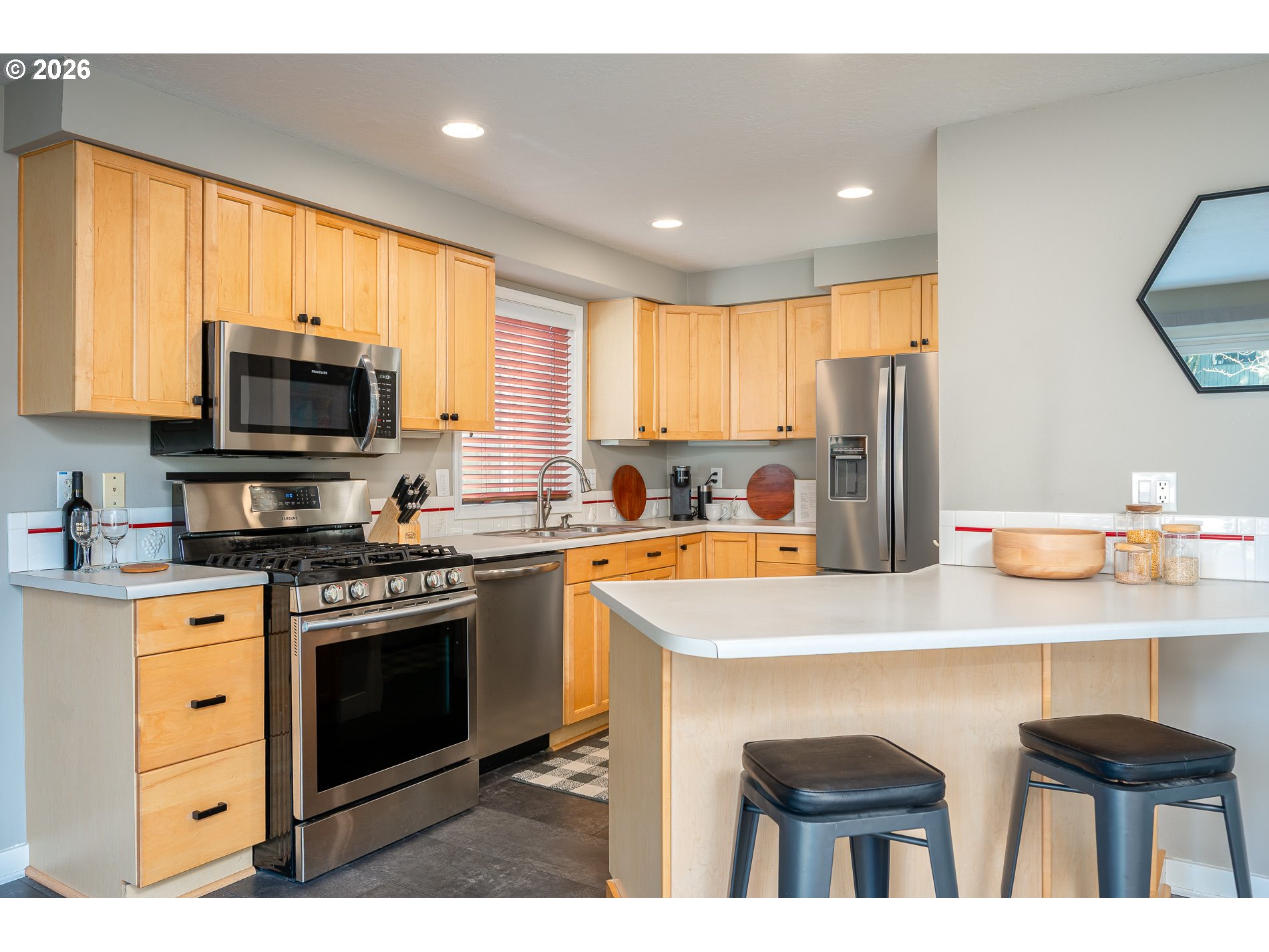 8670 Southwest Stratford Court Tigard, OR 97224 - Photo 20 of 42 a kitchen with stainless steel appliances granite countertop a stove a sink dishwasher a refrigerator and a microwave
