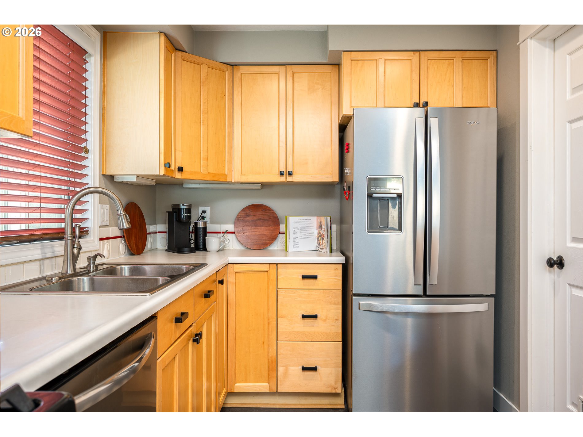8670 Southwest Stratford Court Tigard, OR 97224 - Photo 23 of 42 a kitchen with a refrigerator a sink and a cabinets
