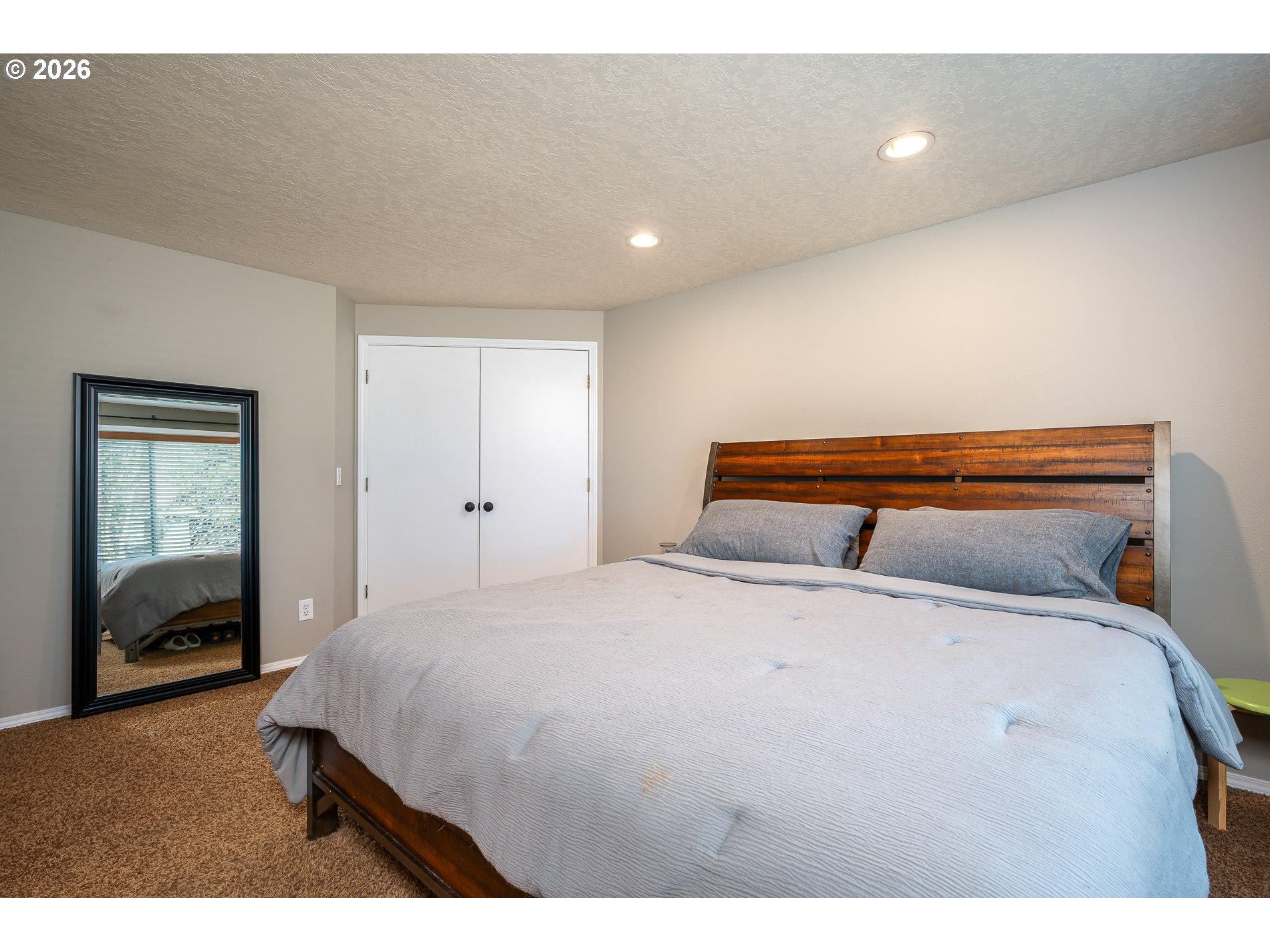 8670 Southwest Stratford Court Tigard, OR 97224 - Photo 27 of 42 a bedroom with a bed and a view of living room