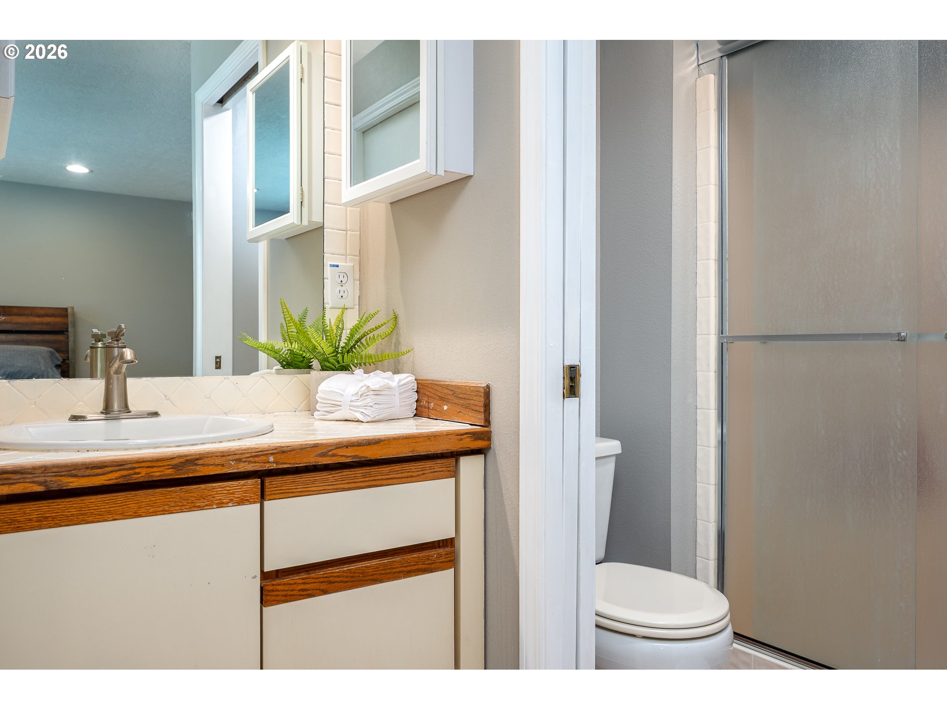 8670 Southwest Stratford Court Tigard, OR 97224 - Photo 28 of 42 a bathroom with a sink a toilet and a mirror