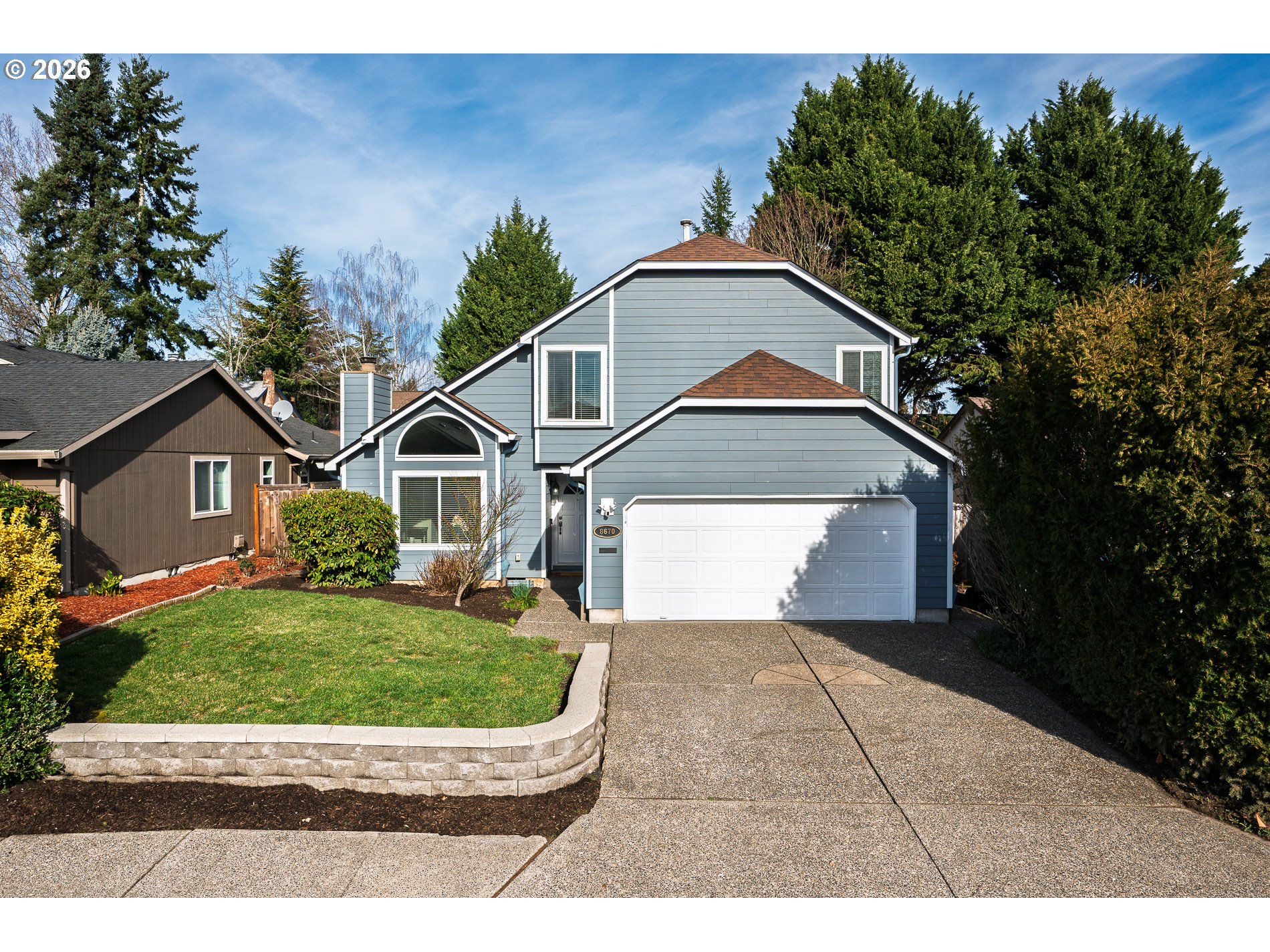 8670 Southwest Stratford Court Tigard, OR 97224 - Photo 3 of 42 a front view of a house with a yard and garage