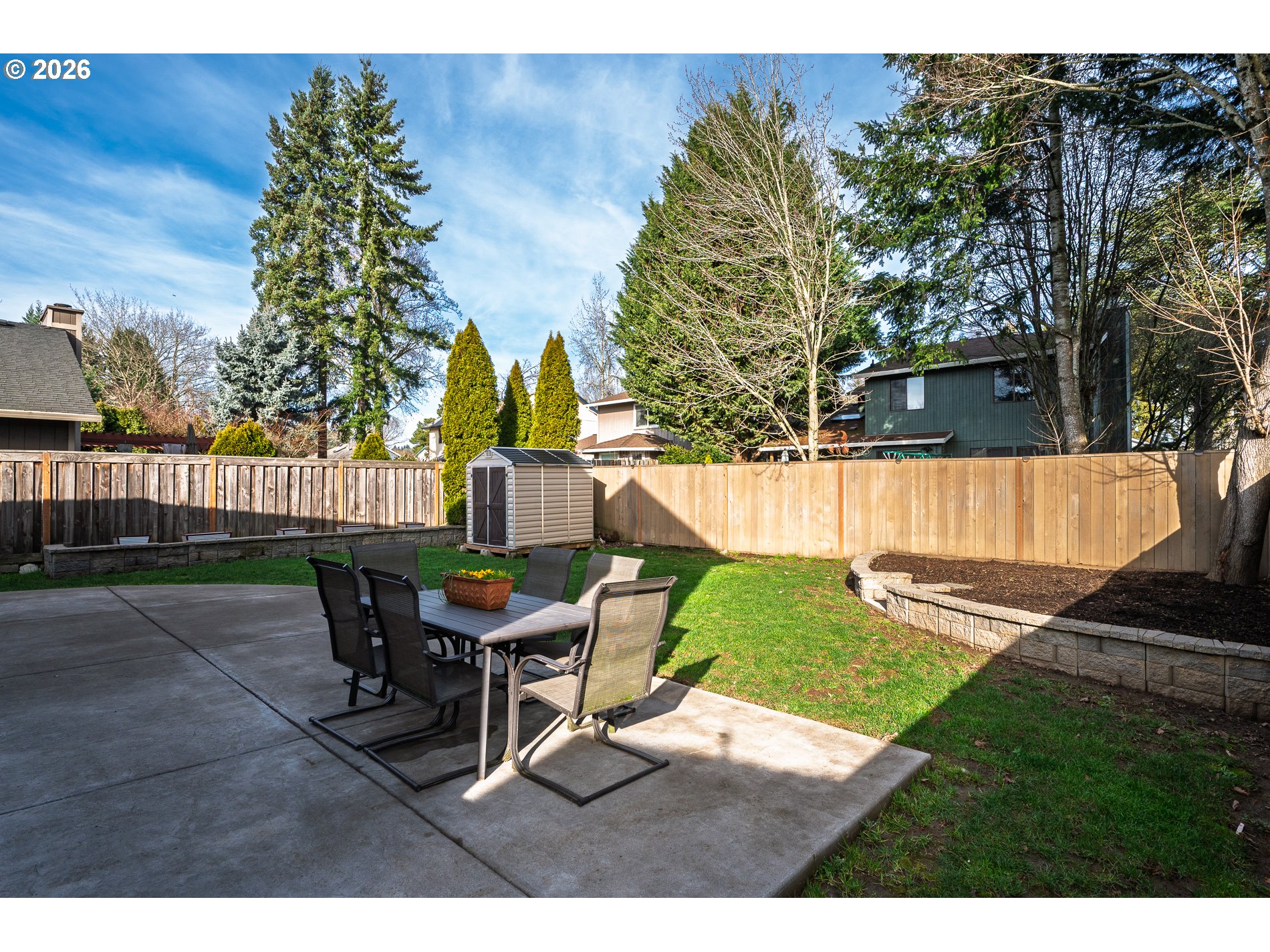 8670 Southwest Stratford Court Tigard, OR 97224 - Photo 34 of 42 a view of a backyard with table and chairs and a yard