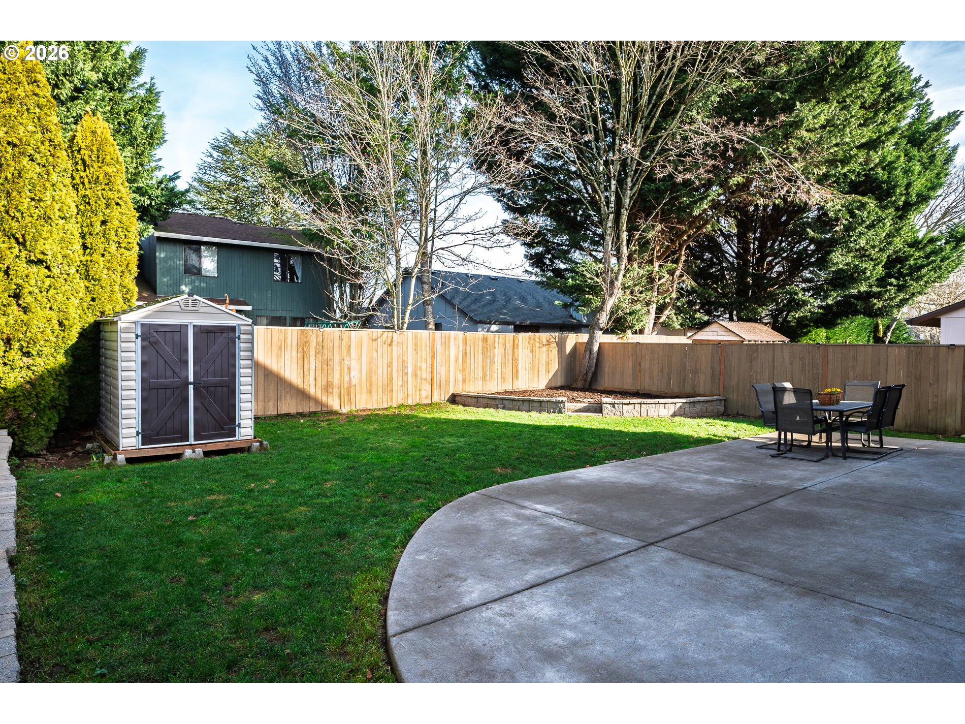 8670 Southwest Stratford Court Tigard, OR 97224 - Photo 40 of 42 a view of a backyard with table and chairs and a tree