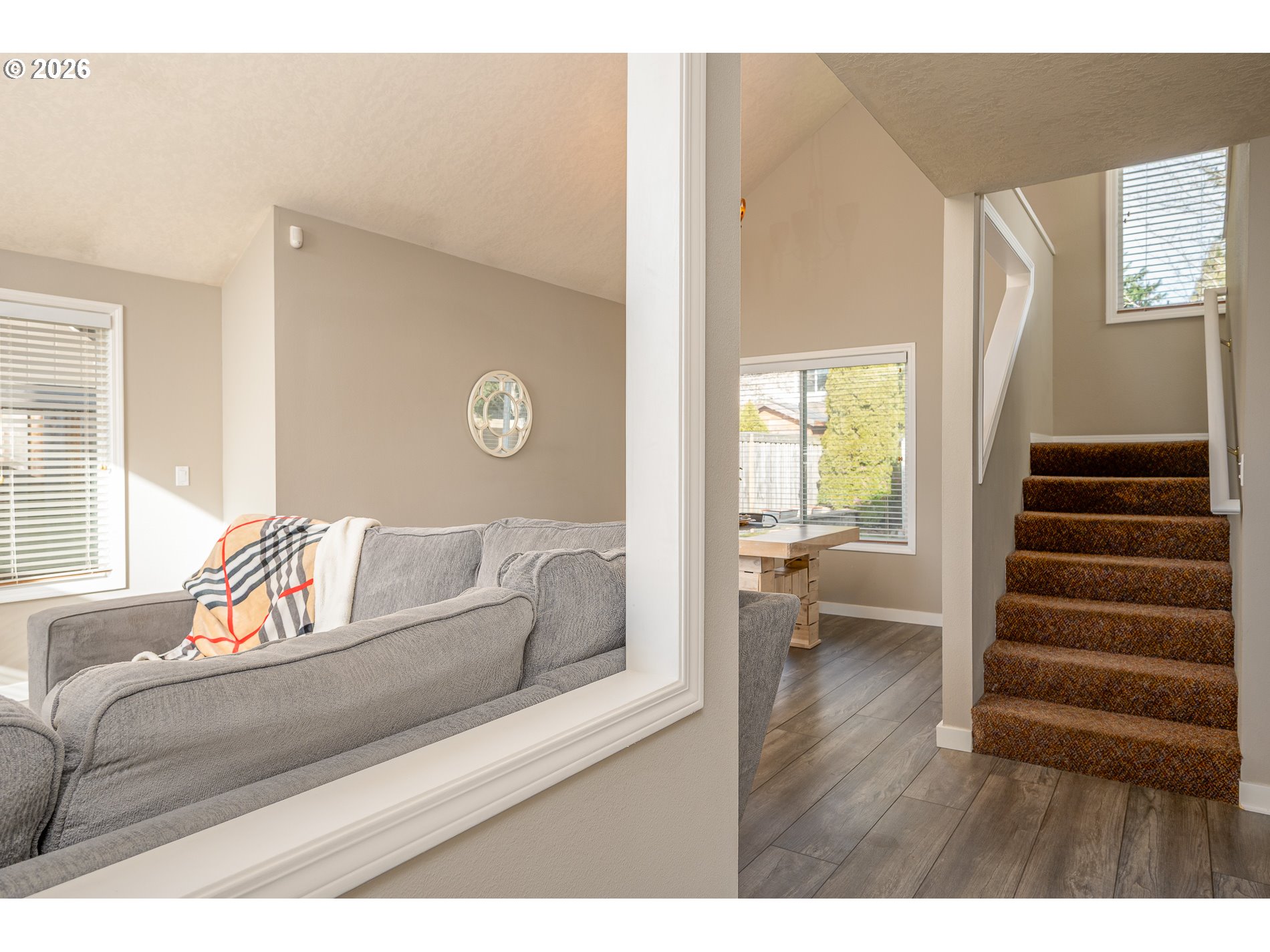 8670 Southwest Stratford Court Tigard, OR 97224 - Photo 6 of 42 a living room with a couch and a wooden floor
