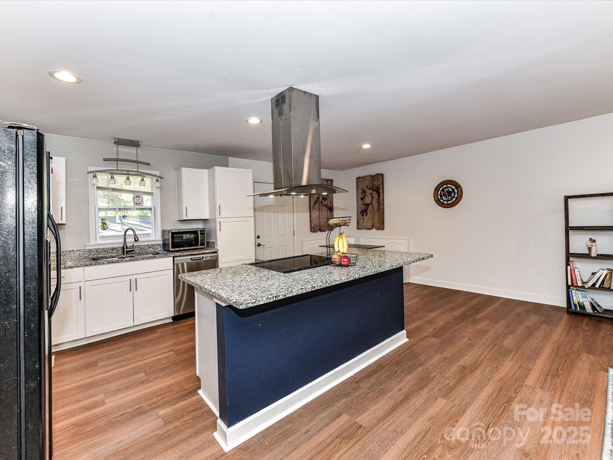 1620 Blueberry Street Mount Pleasant, NC 28124 - Photo 11 of 31 a kitchen with stainless steel appliances granite countertop a sink stove and wooden floor