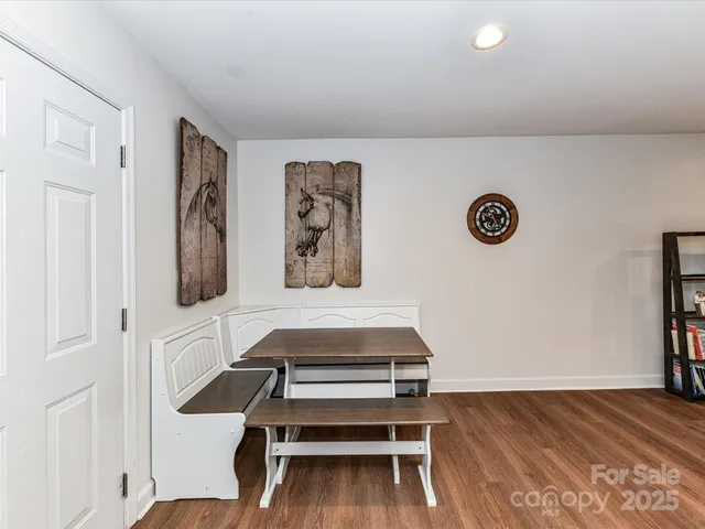 a view of a livingroom with wooden floor and white walls